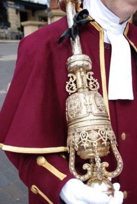 a gilded, ornate mace tied with a black ribbon