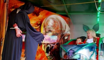 a woman and child sit in a fairground ride
