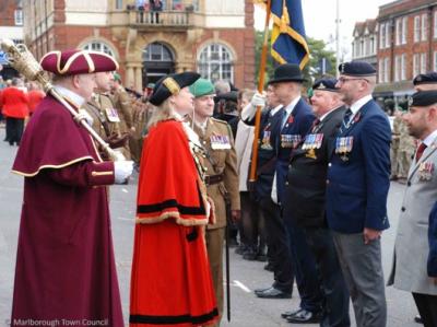 A female mayor in red robes chats to military veterans and representatives of RBL